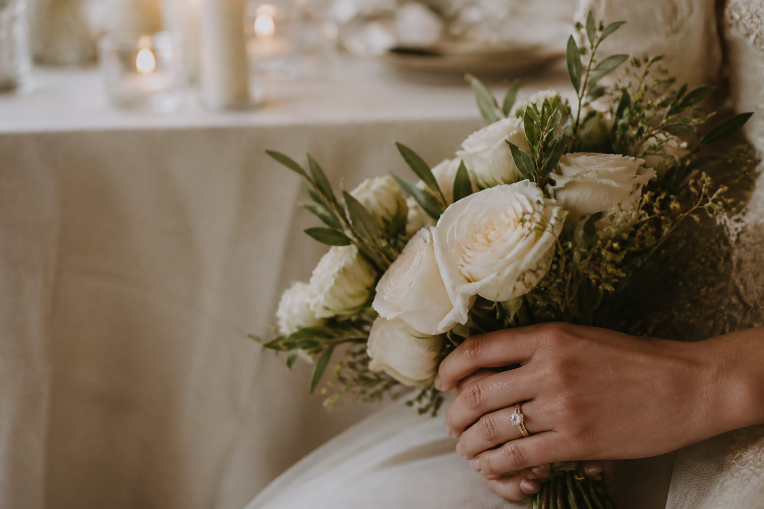 Wedding bouquet and rings on a reception table